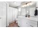 Bright bathroom offers a white vanity, modern lighting, and vinyl flooring at 6459 Titania Dr, Indianapolis, IN 46236