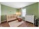 The Bedroom has green walls, natural light, and hardwood floors at 6459 Titania Dr, Indianapolis, IN 46236