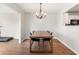Dining room with modern chandelier and large wooden table perfect for entertaining guests at 6459 Titania Dr, Indianapolis, IN 46236