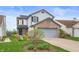 Charming two-story home features a brick facade, attached garage, and landscaped front yard at 6459 Titania Dr, Indianapolis, IN 46236