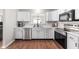 Bright kitchen boasts white cabinetry, stainless steel appliances, and modern countertops at 6459 Titania Dr, Indianapolis, IN 46236