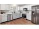 Bright kitchen boasts white cabinetry, stainless steel appliances, and modern countertops at 6459 Titania Dr, Indianapolis, IN 46236