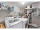 The laundry room features newer washer and dryer units and storage shelving at 6459 Titania Dr, Indianapolis, IN 46236