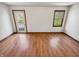 Bright bedroom featuring wood floors, and windows with a view of the outdoors at 6618 Crystal Springs Dr, Avon, IN 46123