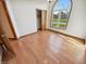 Bedroom featuring an arched window, hardwood floors, and a closet at 6618 Crystal Springs Dr, Avon, IN 46123