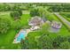 Expansive estate featuring a pool, multiple garages, and verdant lawns at 6990 Old Hunt Club Rd, Zionsville, IN 46077