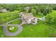 Gorgeous property with a circular driveway, lush landscaping, and a backyard pool at 6990 Old Hunt Club Rd, Zionsville, IN 46077