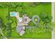 Aerial view of a secluded estate with a pool, circular driveway, and lush greenery at 6990 Old Hunt Club Rd, Zionsville, IN 46077