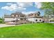 Expansive backyard featuring a brick patio, lush lawn, and manicured landscaping at 6990 Old Hunt Club Rd, Zionsville, IN 46077