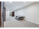Spacious finished basement area featuring carpet flooring, an air hockey table, and sliding barn doors at 6990 Old Hunt Club Rd, Zionsville, IN 46077