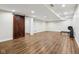 Spacious basement with wood-look floors and a barn door at 6990 Old Hunt Club Rd, Zionsville, IN 46077