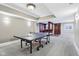 Finished basement with a bar area, a ping pong table and carpet flooring at 6990 Old Hunt Club Rd, Zionsville, IN 46077