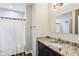 Cozy bathroom with a granite countertop, dark wood cabinets, and shower with curtain at 6990 Old Hunt Club Rd, Zionsville, IN 46077