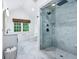 Bright bathroom featuring a glass shower, vanity, and window at 6990 Old Hunt Club Rd, Zionsville, IN 46077