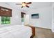 Bright bedroom with ample natural light, ceiling fan, and mounted TV creating a comfortable and inviting space at 6990 Old Hunt Club Rd, Zionsville, IN 46077