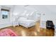 Bright bedroom with hardwood floors, skylights, and a built-in desk at 6990 Old Hunt Club Rd, Zionsville, IN 46077