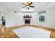Bright bedroom with hardwood floors, trey ceilings, a fireplace, and a large window at 6990 Old Hunt Club Rd, Zionsville, IN 46077
