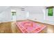 Bright bedroom with large pink rug, hardwood floors and lots of sunlight at 6990 Old Hunt Club Rd, Zionsville, IN 46077