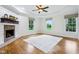 Bright bedroom with hardwood floors, trey ceilings, a brick fireplace, and large windows at 6990 Old Hunt Club Rd, Zionsville, IN 46077