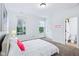 Bright bedroom with a comfortable bed, large windows, and a view to an ensuite bath, and ample natural light at 6990 Old Hunt Club Rd, Zionsville, IN 46077