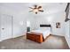 Cozy bedroom with a ceiling fan, accent light and a unique platform bed with built-in storage enhancing the room's charm at 6990 Old Hunt Club Rd, Zionsville, IN 46077