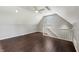 A bonus room with hardwood floors, bright lighting, and a staircase leading to the lower level at 6990 Old Hunt Club Rd, Zionsville, IN 46077