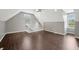 A large bonus room offers hardwood floors and multiple windows for natural light with stairs going down at 6990 Old Hunt Club Rd, Zionsville, IN 46077