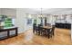 Well-lit dining area adjacent to a modern kitchen, featuring a bay window and a stylish chandelier at 6990 Old Hunt Club Rd, Zionsville, IN 46077