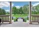 Welcoming entryway showcasing a circular driveway, fountain, and lush greenery framed by stately columns at 6990 Old Hunt Club Rd, Zionsville, IN 46077