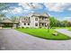 Charming two-story home with a circular driveway and well-maintained landscaping at 6990 Old Hunt Club Rd, Zionsville, IN 46077