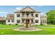 Elegant two-story home featuring a circular driveway with a beautiful water fountain at 6990 Old Hunt Club Rd, Zionsville, IN 46077