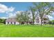 Two-story home featuring a large front yard and a classic architectural design at 6990 Old Hunt Club Rd, Zionsville, IN 46077