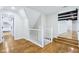 Bright hallway with hardwood floors and white trim leading to a bedroom at 6990 Old Hunt Club Rd, Zionsville, IN 46077