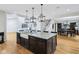 Spacious kitchen island with granite countertops, a farmhouse sink, and modern pendant lighting at 6990 Old Hunt Club Rd, Zionsville, IN 46077