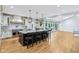 Bright kitchen featuring a large island with seating, pendant lighting, and stainless-steel appliances at 6990 Old Hunt Club Rd, Zionsville, IN 46077