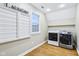 Functional laundry room with modern washer and dryer, window, and ample space, making chores a breeze at 6990 Old Hunt Club Rd, Zionsville, IN 46077