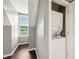 An upstairs laundry room features a stackable washer and dryer and a window with natural light at 6990 Old Hunt Club Rd, Zionsville, IN 46077
