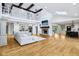 Bright open-concept space with hardwood floors, high ceilings, a fireplace, and an upstairs balcony at 6990 Old Hunt Club Rd, Zionsville, IN 46077