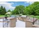 Outdoor kitchen and bar featuring a sink and stainless steel appliances at 6990 Old Hunt Club Rd, Zionsville, IN 46077