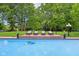 In-ground pool with brick coping, lounge chairs and a large lawn at 6990 Old Hunt Club Rd, Zionsville, IN 46077