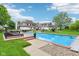 Large swimming pool with a brick border, patio and a large lawn at 6990 Old Hunt Club Rd, Zionsville, IN 46077