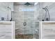 Luxurious walk-in shower with dual showerheads, tiled walls, and a built-in bench at 6990 Old Hunt Club Rd, Zionsville, IN 46077