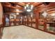 Spacious custom wood wine room with individual wine racks and tile flooring at 6990 Old Hunt Club Rd, Zionsville, IN 46077