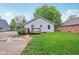 Backyard view of house with green lawn, wooden deck, and a well-maintained yard at 709 S Meridian St, Lebanon, IN 46052