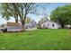 Large backyard featuring lush green grass, shed, and plenty of space for recreation at 709 S Meridian St, Lebanon, IN 46052