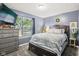 Cozy bedroom features comfortable queen bed, dresser, and a window with natural light at 709 S Meridian St, Lebanon, IN 46052