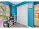 Bright blue bedroom with a play kitchen and a double door closet at 709 S Meridian St, Lebanon, IN 46052