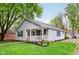 Well-manicured front lawn with a single-story home featuring a charming covered porch and light gray siding at 709 S Meridian St, Lebanon, IN 46052