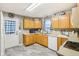 Functional kitchen with light wood cabinets, white appliances, neutral countertops, and modern fixtures at 709 S Meridian St, Lebanon, IN 46052