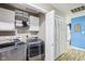 Well-equipped laundry room with modern washer and dryer, cabinets, and a folding area at 709 S Meridian St, Lebanon, IN 46052